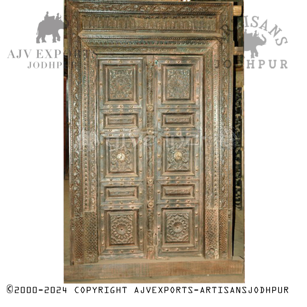 Intricately carved door with brass accents
